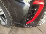 a close up of a black car with a red stripe on it