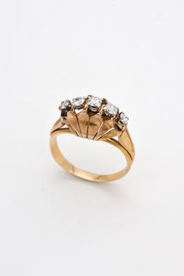 a close up of a gold ring with three diamonds on it