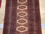 rug on the floor is brown and red with a design on it
