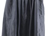 black skirt hanging on a hanger on a white wall