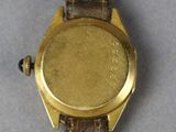 a close up of a watch on a table