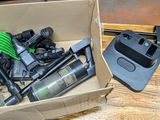 a cardboard box filled with assorted items on a wooden table