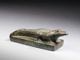 an egyptian bronze statue of a dog on a stone base