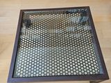 a coffee table with a glass top sitting on a wooden floor