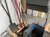 un seau et une pelle posés sur une palette dans un garage