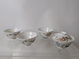 four bowls sitting on a glass shelf in a room