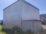an image of a building in the middle of a field