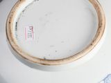 a blue and white porcelain bowl with a gold rim