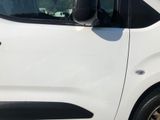 a man standing on the side of a white van
