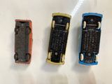 three small toy cars sitting next to each other on a table