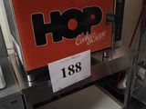 a picture of a coffee machine with a sign on it