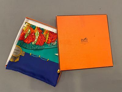 an orange box with a blue and orange scarf inside of it