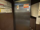 an image of a stainless steel refrigerator in the corner of a room