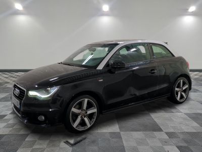the black car is parked in the garage on the checkered floor