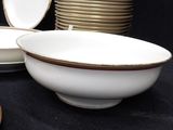 a lot of plates and bowls sitting on a table