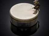 a silver box with a bird on top of it