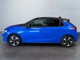a blue car is parked in a room with a white wall