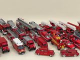 a lot of toy fire trucks that are sitting on a table