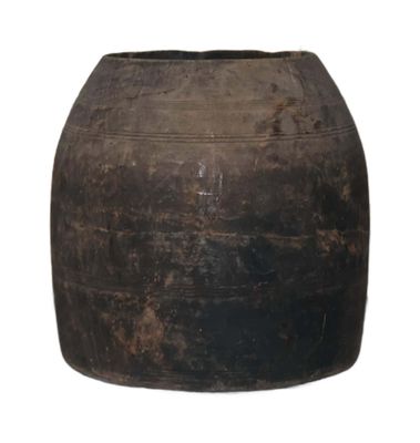 a large brown pot sitting on a white surface