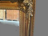 a mirror that is sitting on the floor in the room