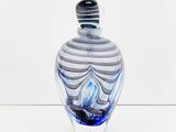 a glass vase with a blue and white design on it