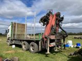 a truck that is sitting in the grass with a bunch of equipment