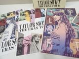a lot of taylor swift posters on the table