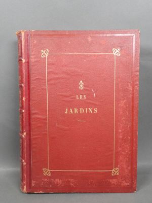 a red book sitting on top of a table next to a gray wall