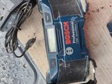 an image of a corded drill is sitting on the floor next to other tools
