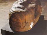 a picture of a piece of wood with a face on it