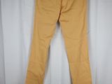 a pair of yellow jeans hanging on a white curtain