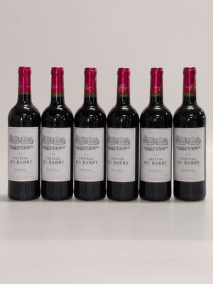 six bottles of red wine lined up in a row