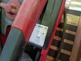 a close up of a red and green fire hydrant with a gauge