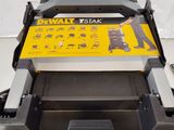 a close up of a black and yellow lawn mower on a white surface