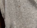 a close up of a person wearing a sweater and tie