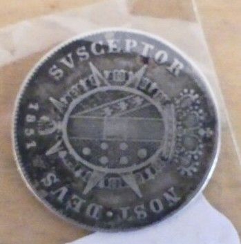 an old silver coin with a picture of a train on it