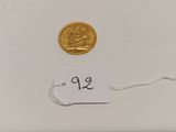 a close up of a gold coin with a price tag on it
