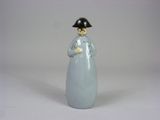 a figurine of a woman with a hat on her head