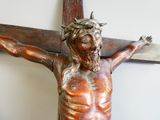 a statue of jesus on the cross with a knife in his hand