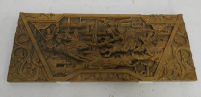 an old carved wooden plaque with a picture of a man on a horse