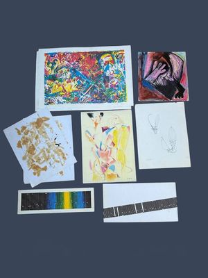 a lot of art work on display on the table