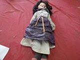 a doll that is laying on a blanket on the floor