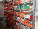 a room with many shelves and bins of assorted items