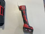 a cordless drill on the wall next to a battery