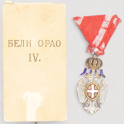 une image représentant une médaille ornée d'un ruban rouge et d'une croix