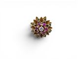 un gros plan d'une bague violette et dorée posée sur une surface blanche