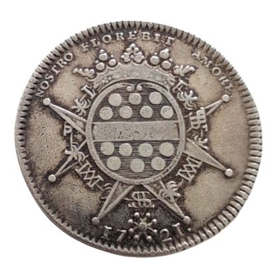 une vieille pièce d'argent sur laquelle figurent des armoiries et une croix