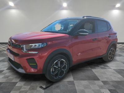the red 2020 kia soul is parked on a checkered floor