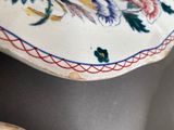 three plates with flowers on them sitting on a table