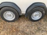 a trailer that has two tires on the side of it